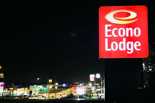 a sign for a corona lodge on the side of a gas station at Econo Lodge Ardmore in Ardmore