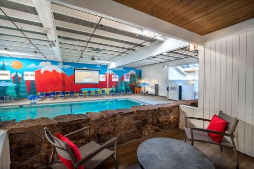 a swimming pool with chairs and a red pillow at Holiday Inn Estes Park by IHG in Estes Park