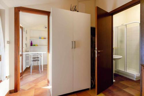 a large white cabinet in a room with a kitchen at R22 - Casa Geranio: delizioso appartamentino in Marcelli