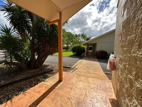 a patio with an umbrella on the side of a building at Mareeba Motor Inn in Mareeba