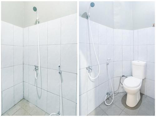 a bathroom with a shower and a toilet in it at FAI Bogor Backpacker by SPAZIE in Bogor
