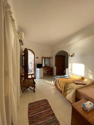 a hotel room with two beds and a table at Dahab , property company Lighthouse area in Dahab