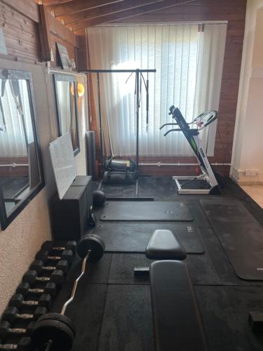 a room with a gym with a treadmill and weights at Pissouri Villa Miramar in Pissouri