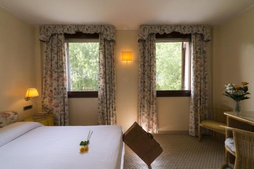Postel nebo postele na pokoji v ubytování Relais Leon d'Oro