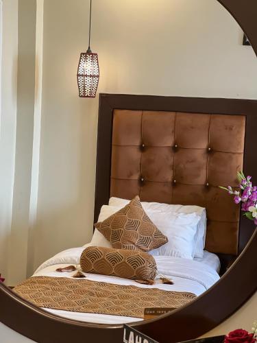 a bedroom with a bed with a large mirror at Hotel One Swat in Swat