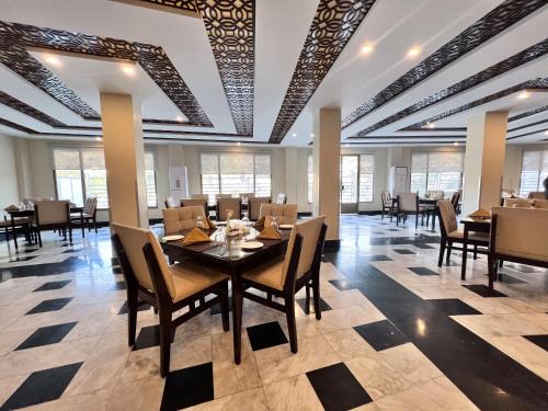 a dining room with a table and chairs at Hotel One Swat in Swat