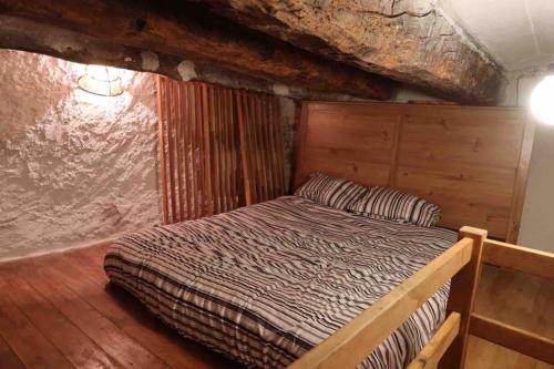 1 dormitorio con 1 cama en una habitación de madera en Cal Fusté de Peramola, en Peramola