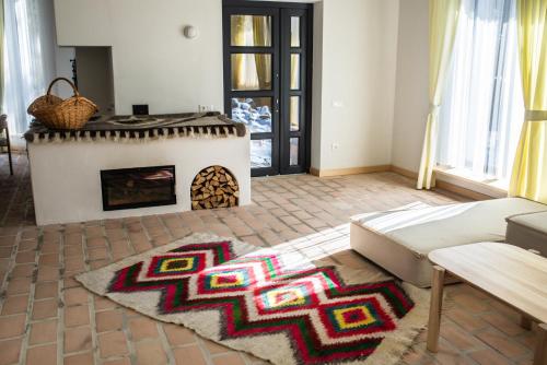 a living room with a fireplace and a couch at Grand Villla Skyta in Vorokhta