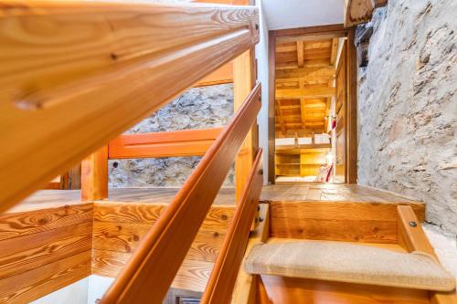 a set of stairs in a room with wooden walls at Arpy an in Morgex
