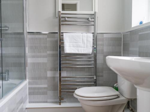 a bathroom with a toilet and a sink at East House - Inviting 3 Bed Stakeford in Choppington