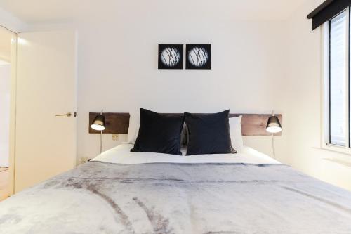 a bedroom with a large bed with two lamps at StayInn Covent Garden in London