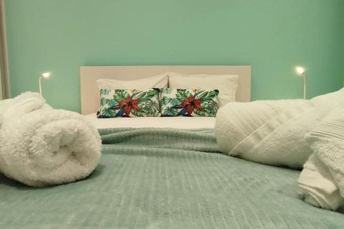 a bed with a stuffed animal laying on top of it at Casa do Ilhéu in Vila Franca do Campo