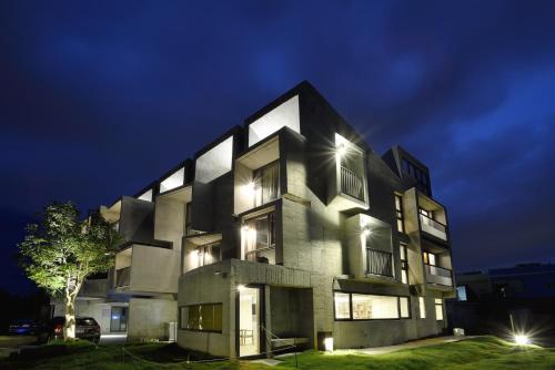 a building that is lit up at night at The Light in Hengchun