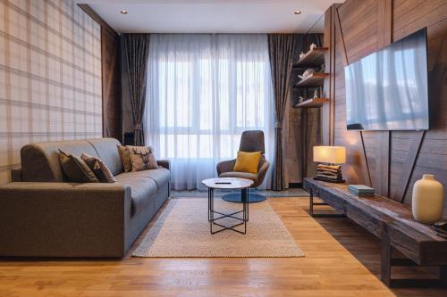 a living room with a couch and a chair at MODERN MOUNTAIN II in Kolašin