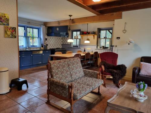 a kitchen and living room with a table and chairs at Holiday home bos en heide in Otterlo