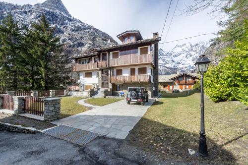 a house with a street light in front of it at In centro a Courmayeur Mont Blanc in Courmayeur