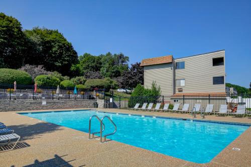 a large blue swimming pool in front of a building at Lakeside Delight, unit 423 in Laconia