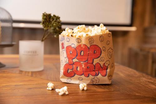 a bag of popcorn sitting on top of a table at 173 ON THE ISLAND enoshima private villa 江の島仲見世通り徒歩3分にある1日1組限定の貸切別荘 in Fujisawa