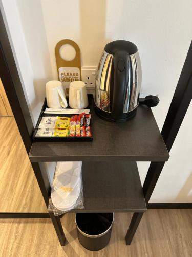 a black table with a tea kettle on it at The Gallivant Hotel in George Town