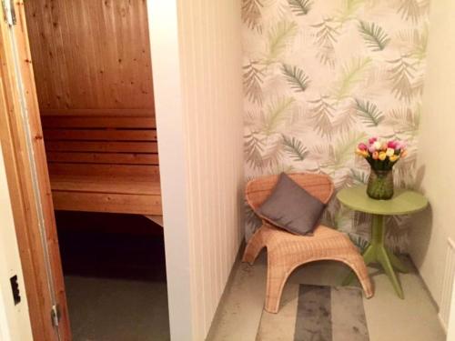 a hallway with a vase of flowers on a wall at Views of Isaberg and fitting two families! in Hestra