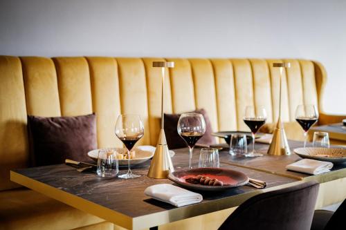a wooden table with glasses of wine on it at Antico Borgo di Sutri in Sutri