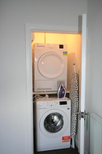 a washer and dryer with a box on top of it at The Lodgings 3 Bed Cottage suitable for families breaks, working away Lincoln in Laneham