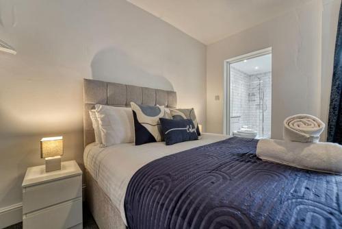 a bedroom with a large bed and a window at Guest Homes - Droitwich Road Apartment in Worcester