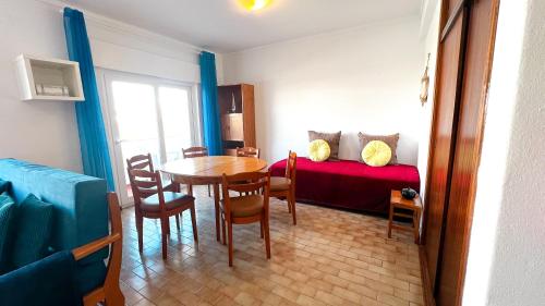 a small room with a table and a bed at Apartamentos Oura AreiaSol by Sunny Deluxe in Albufeira
