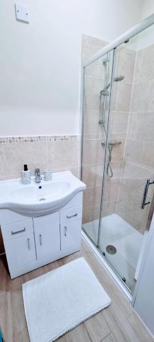 a bathroom with a sink and a shower at Oasis Holiday Home Blackpool in Blackpool