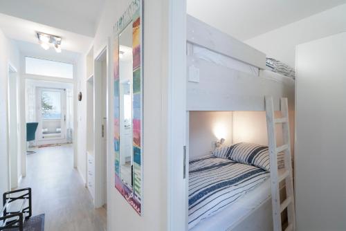 a bedroom with a bunk bed and a hallway at Ferienpark Sierksdorf App 51 - Strandlage in Sierksdorf