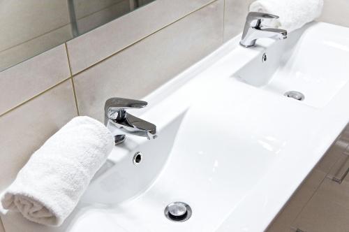 a bathroom with a white sink and a towel at La Rotonde - Appartement 1 chambre aux Chartrons in Bordeaux