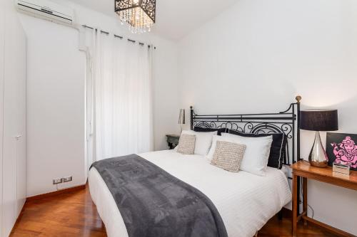 Schlafzimmer mit einem schwarzen und weißen Bett und einem Fenster in der Unterkunft S. Cosimato Trastevere in Rom