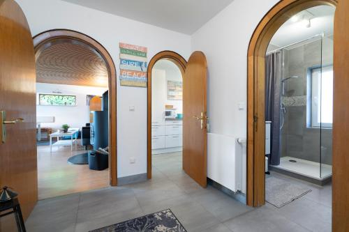 a hallway with two arched doors and a kitchen at Objekte im Umland Ferienhaus Leihberg in Pelzerhaken