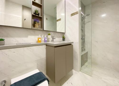 a bathroom with a sink and a shower at Amazing KLCC SKY view infinity pool Eaton Residences Suites in Kuala Lumpur