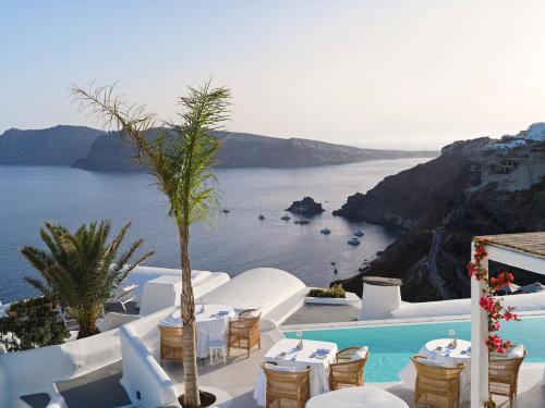 a restaurant with a view of the ocean at Katikies Santorini - The Leading Hotels Of The World in Oia