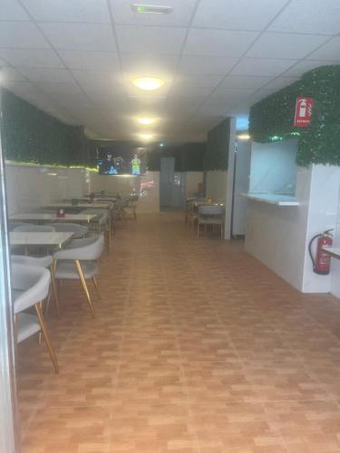 a room with tables and chairs in a restaurant at Limin Hostel Capsules in Valencia