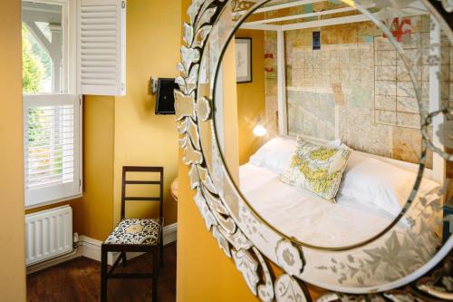 a bedroom with a bed in a mirror at Rum Doodle, Windermere B&B in Windermere