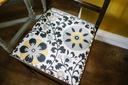 a black and white chair with flowers on it at Rum Doodle, Windermere B&B in Windermere