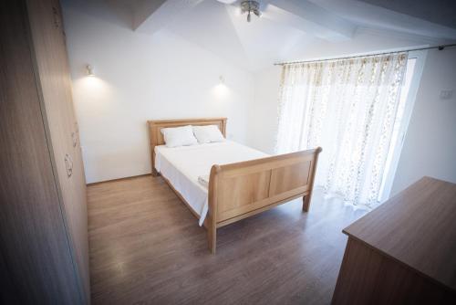 a bedroom with a bed and a large window at Villa Katerina & Pool in Gevgelija