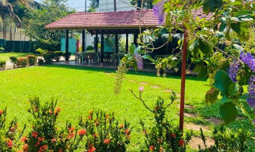 a garden with a gazebo in a yard at Hotel TK Green Garden in Matara