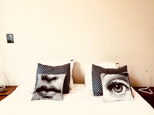 a bed with two pillows with an eye on it at Belle de Nuit in Ostend