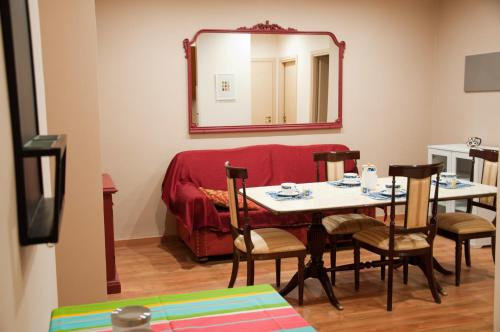 a dining room with a table and a mirror at B&B Chaplin in Favara