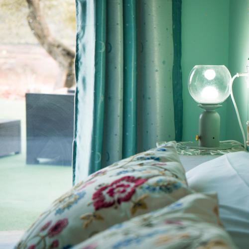 a bed with a pillow and a lamp on a table at Cabezo Buñuel alojamiento Rural in Calanda