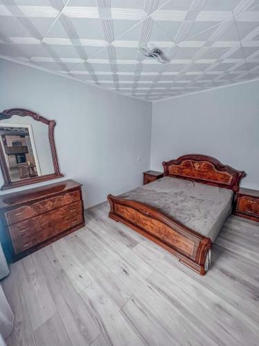 a bedroom with a bed and a mirror on the ceiling at Misko-5 in Šilutė