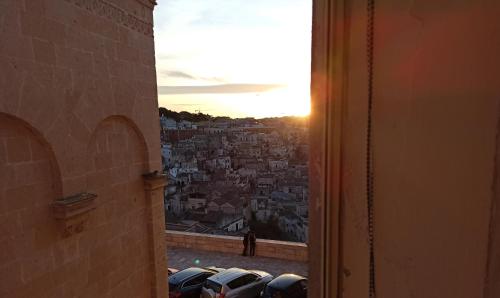 a view from a window of a city at sunset at Riscatto 1514 in Matera
