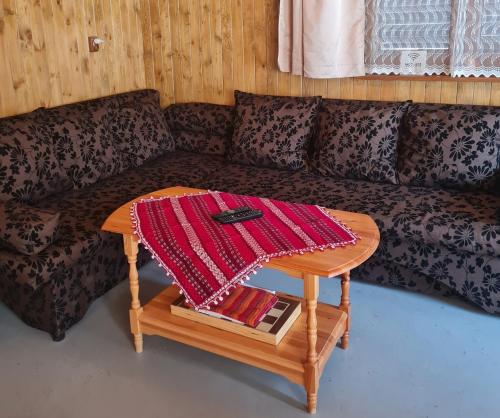 a living room with a couch and a table at Вила Вайлин in Batak