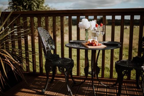 a table with a plate of fruit on a balcony at The Ginger Nut in Welshpool
