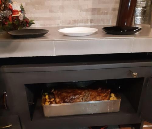a meal is being cooked in an oven at Вила Вайлин in Batak
