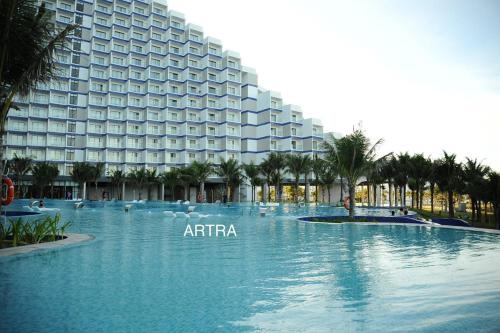 a large swimming pool in front of a hotel at Sea Moon Cam Ranh Beach House in Cam Ranh