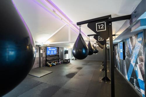 a gym with hanging boxing equipment in a room at The Waterside Hotel and Leisure Club in Manchester